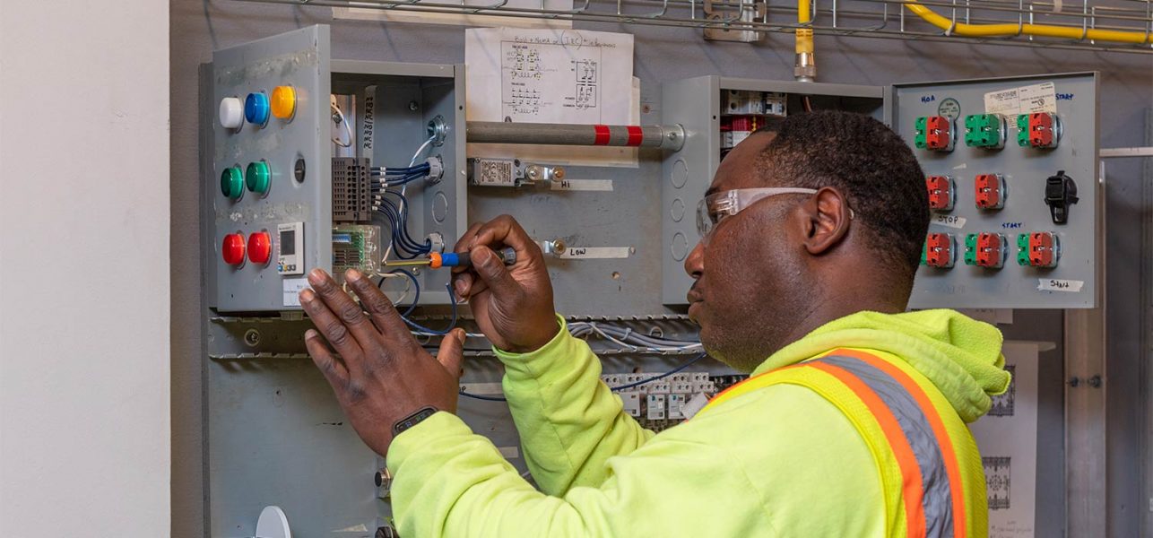 Electrical Trades Center Apprentice training on electrical panel